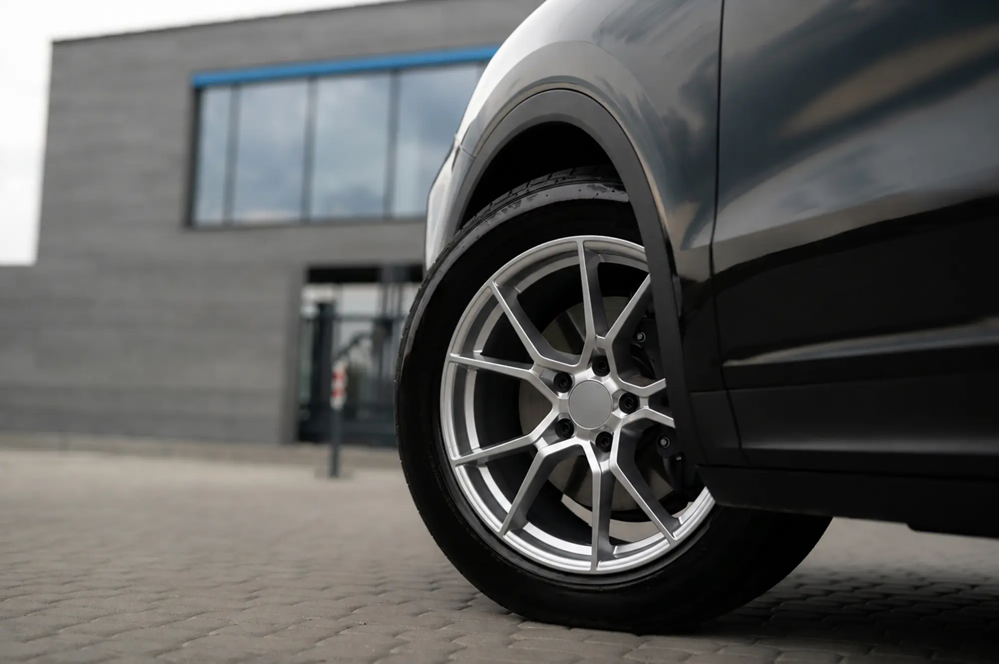 Sleek car details on cobblestone ground